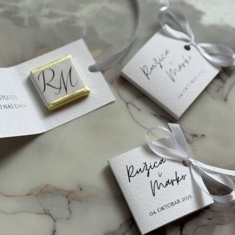 Elegant wedding favor tags with calligraphy and satin ribbons for wedding decor and invitations.
