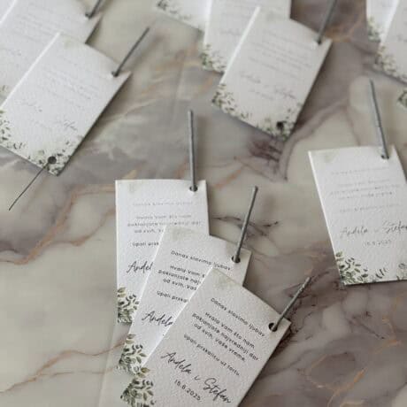 Elegant wedding invitation cards with floral design on marble surface for a romantic wedding celebration.