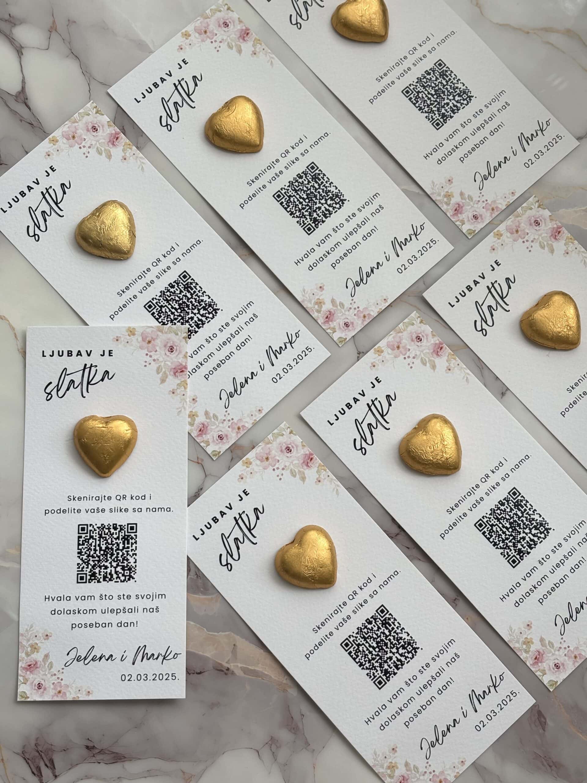 Heart-shaped chocolates on wedding invitation cards with QR codes for photo sharing.