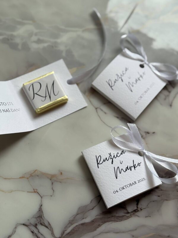 Elegant wedding favor tags with calligraphy and satin ribbons for wedding decor and invitations.