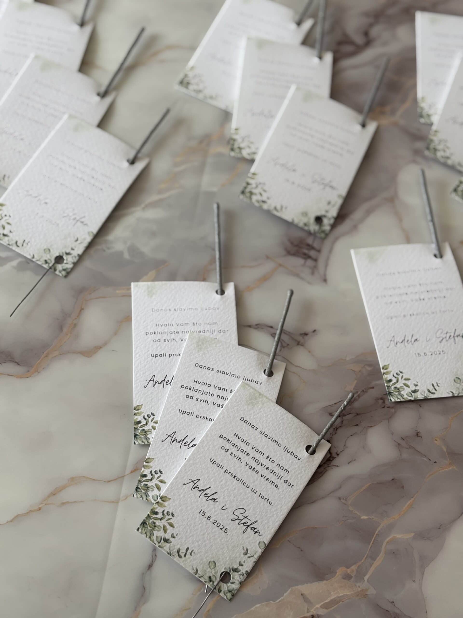 Elegant wedding invitation cards with floral design on marble surface for a romantic wedding celebration.