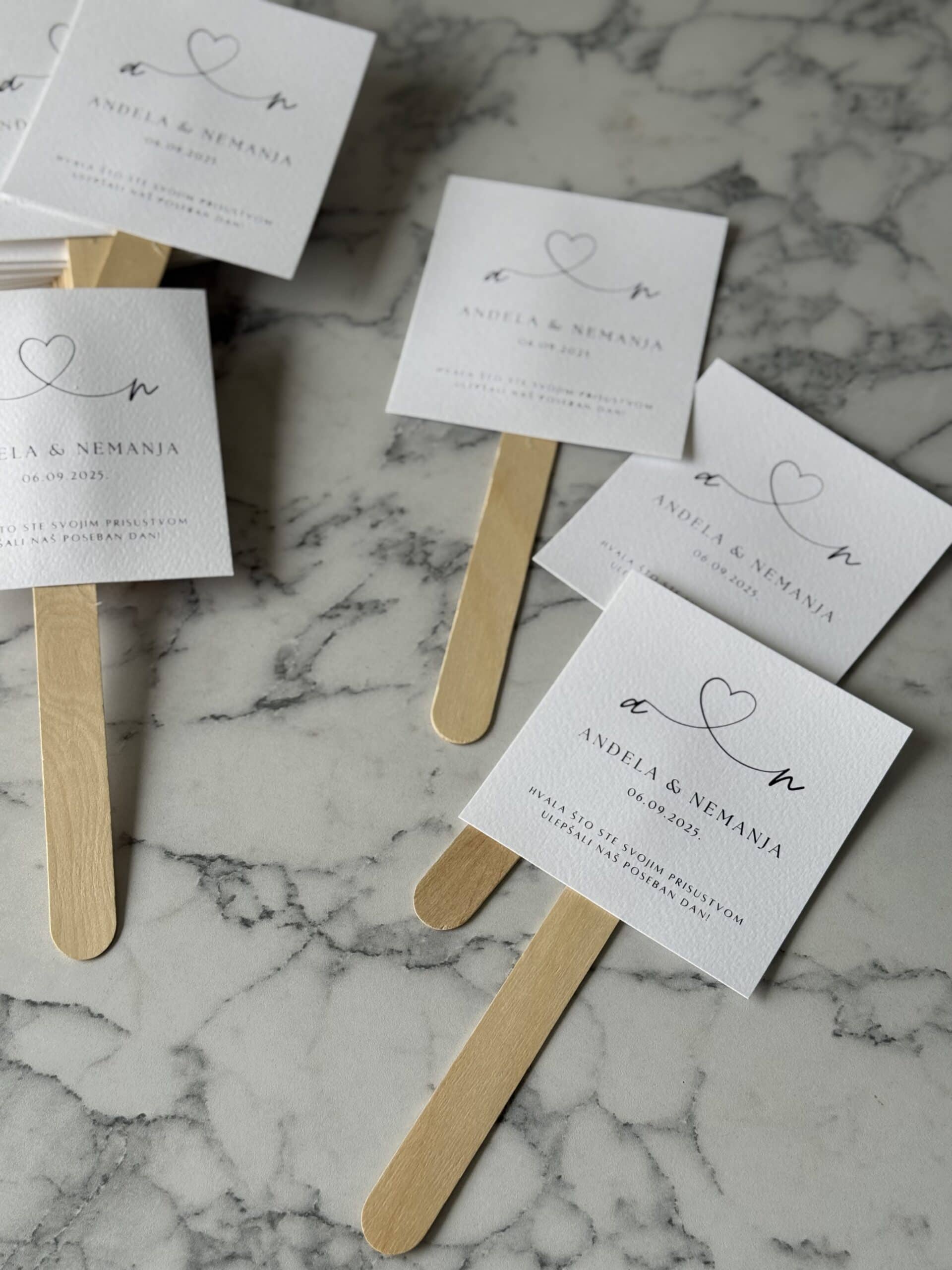 Elegant wedding favor tags with minimalist design, featuring hearts and personalized text.